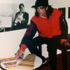 Michael Jackson sat down, next to a kid-sized table that held three toy xylophones